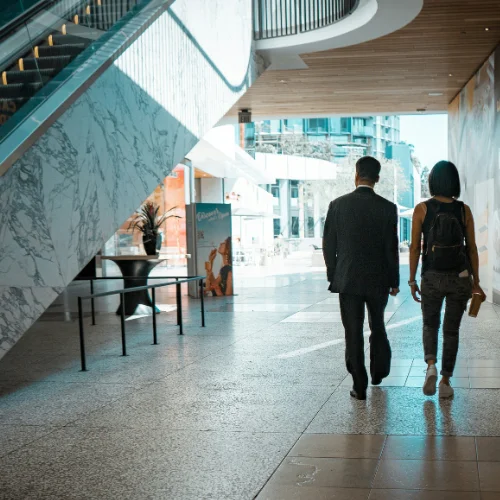 ShoppingCentersOffering two people walking away from the camera in a shopping center