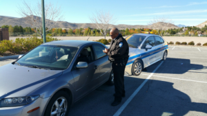 security guard talking to someone who is in their car
